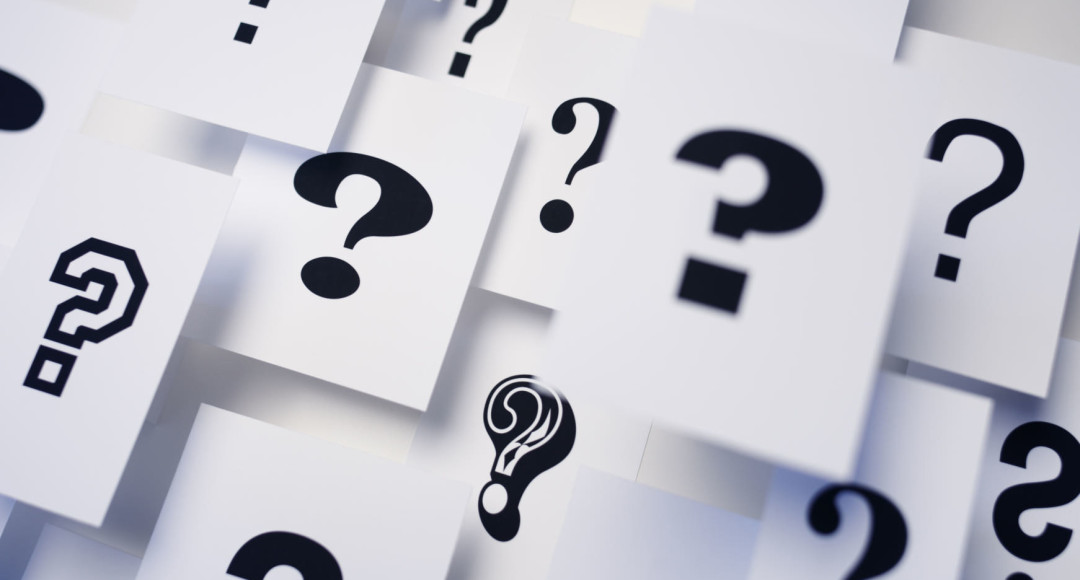 Multiple question marks on paper